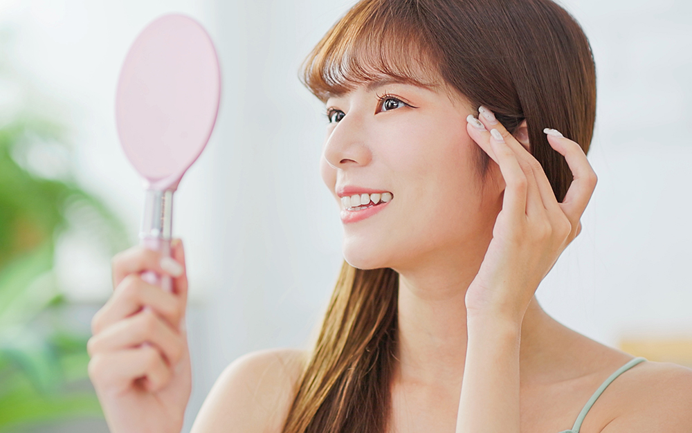 Young asian woman look mirror Rhinoplasty in Phoenix, AZ