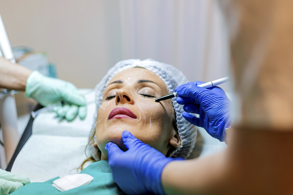 Beautician touch and draw correction lines on woman face Facelift in Phoenix, AZ